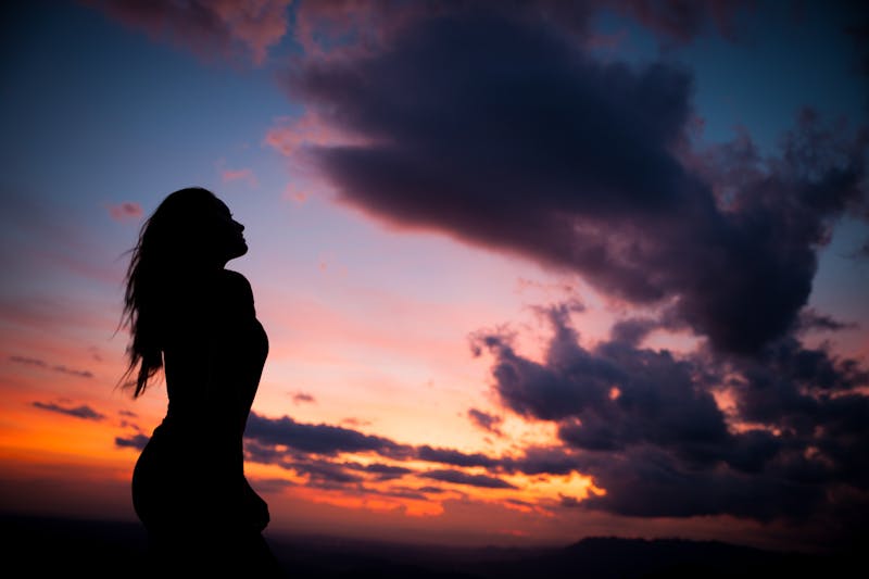 Silhouette of a woman at sunset