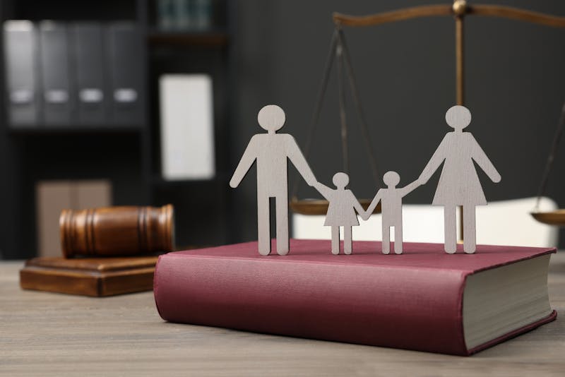 A cut-out of a family on a book