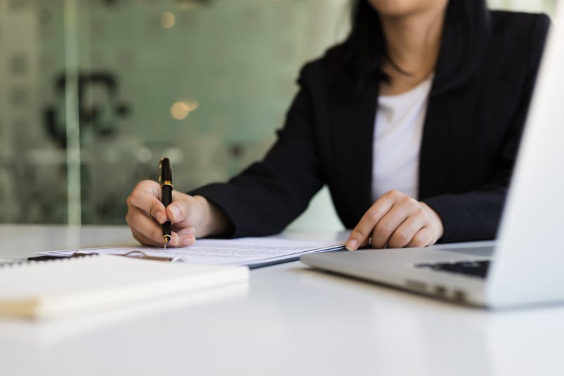 A woman signing a document