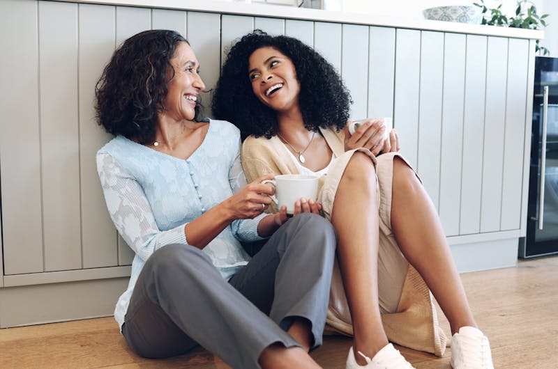 A woman and her mom sitting on floor