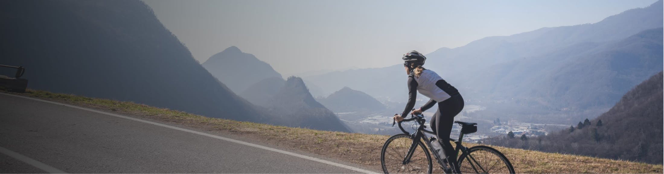 person riding a bike up a hill