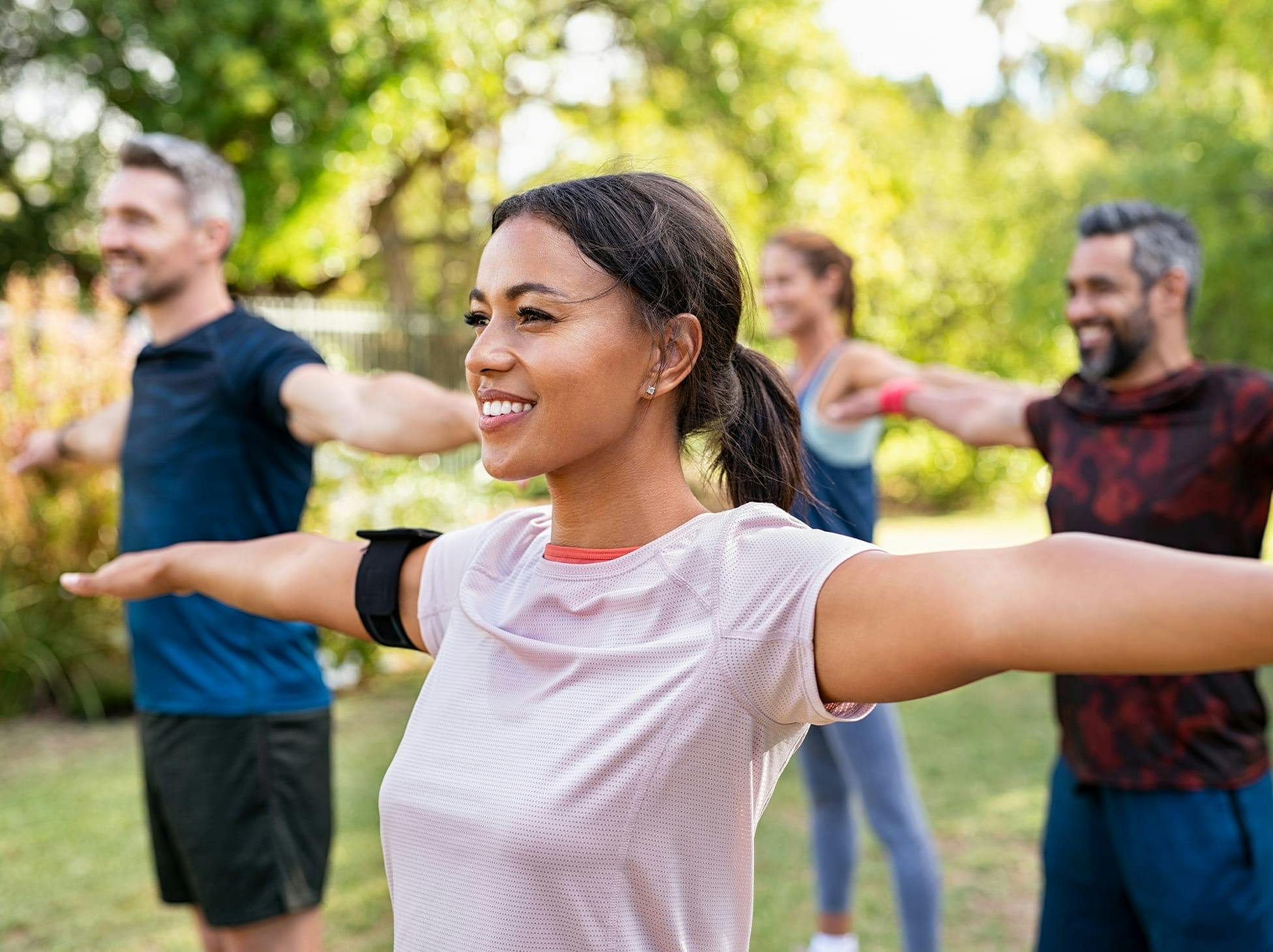 people doing stretches in a park