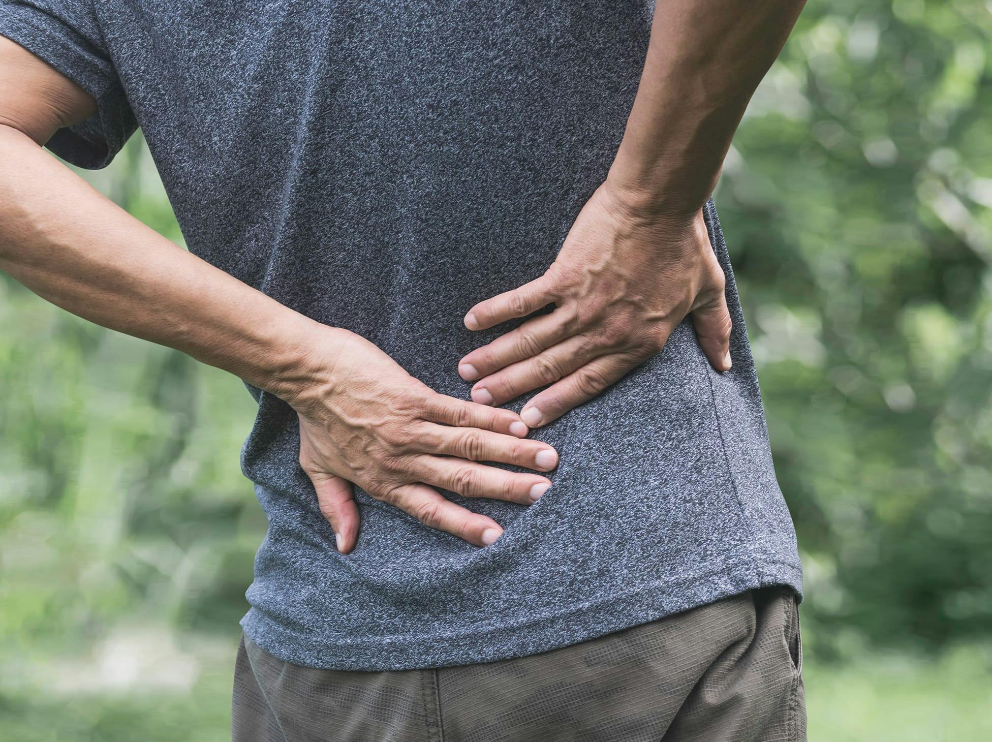 man holding his lower back