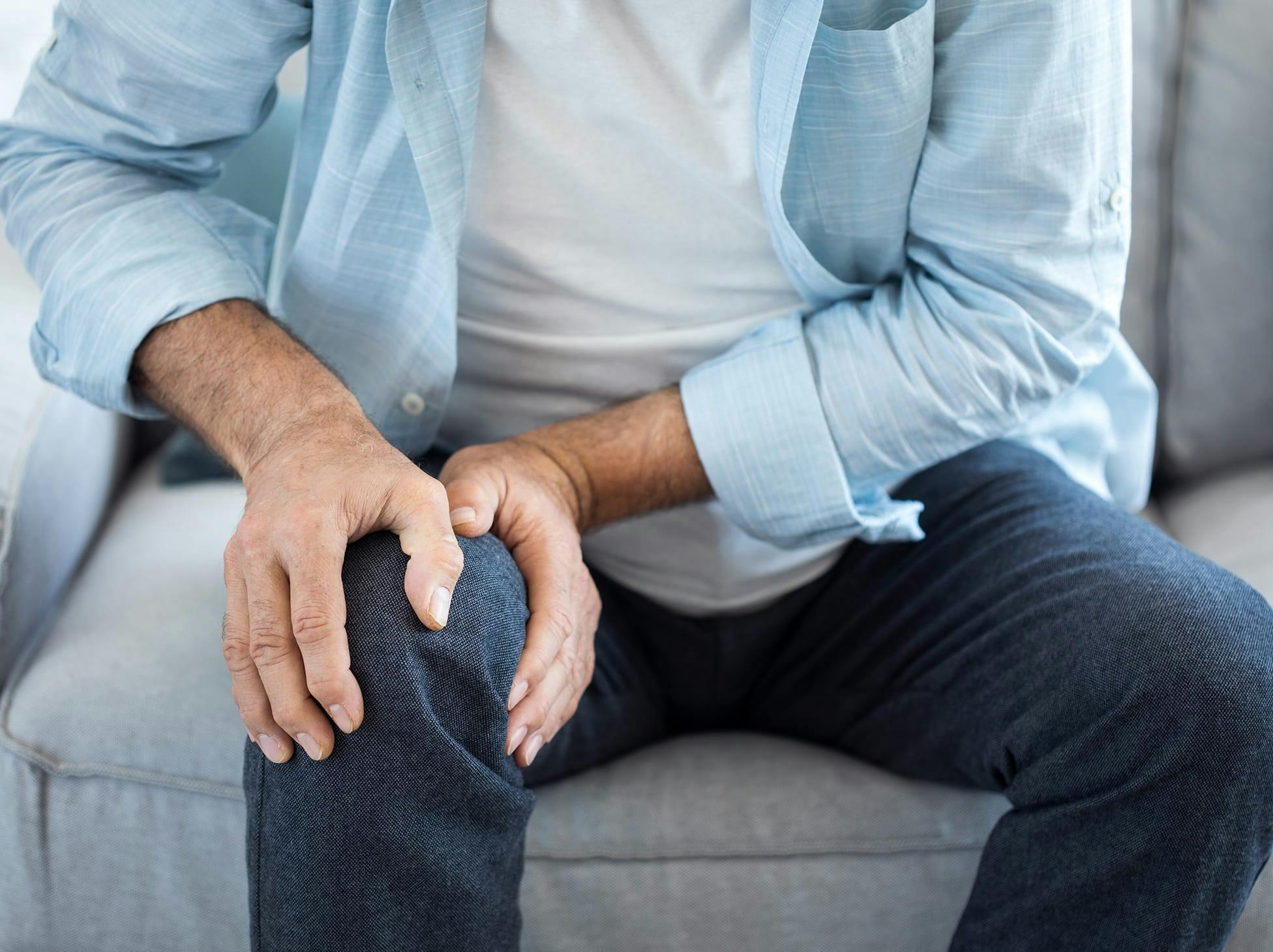man holding his knee