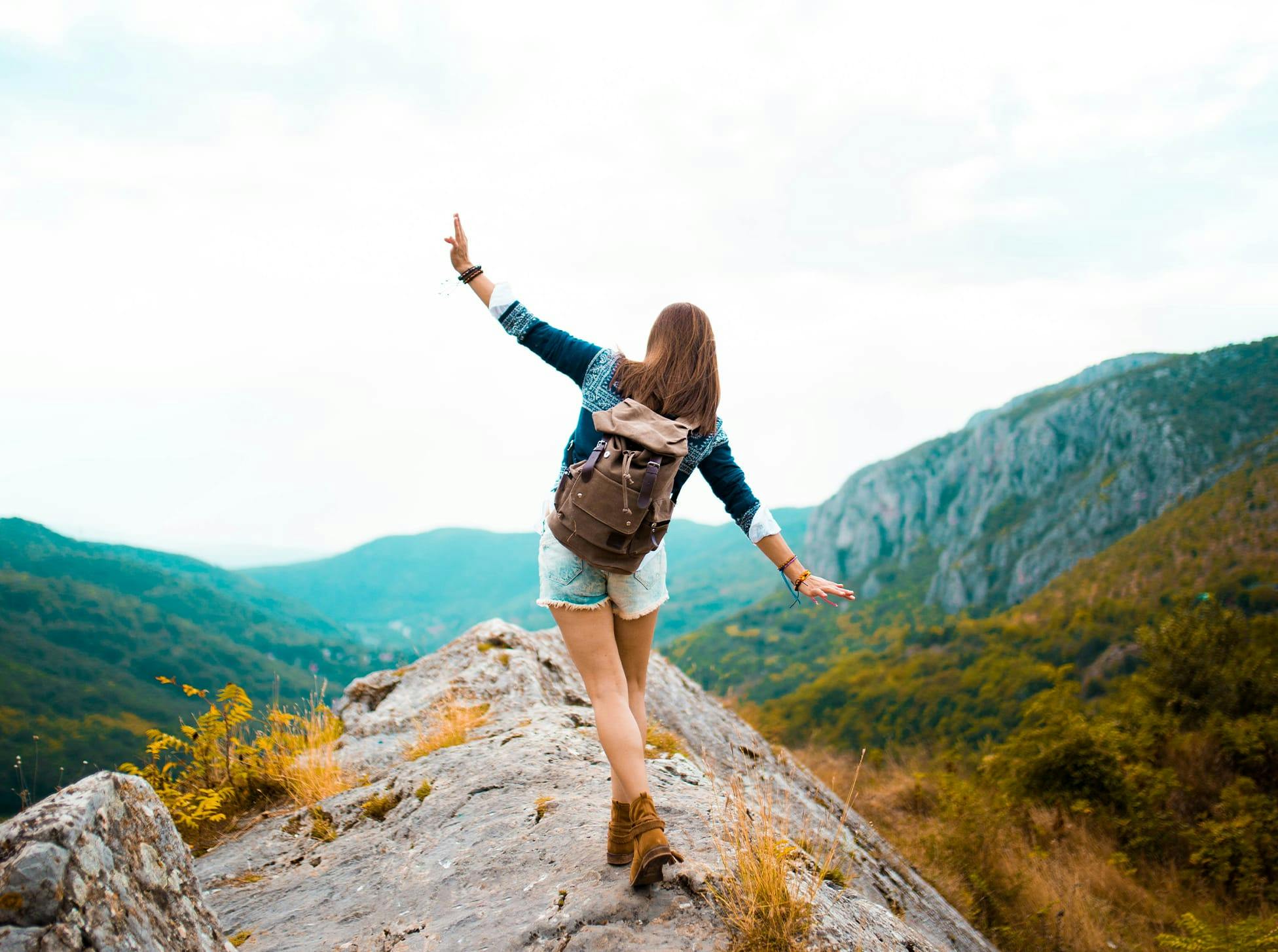 woman standing on a rocky mountain