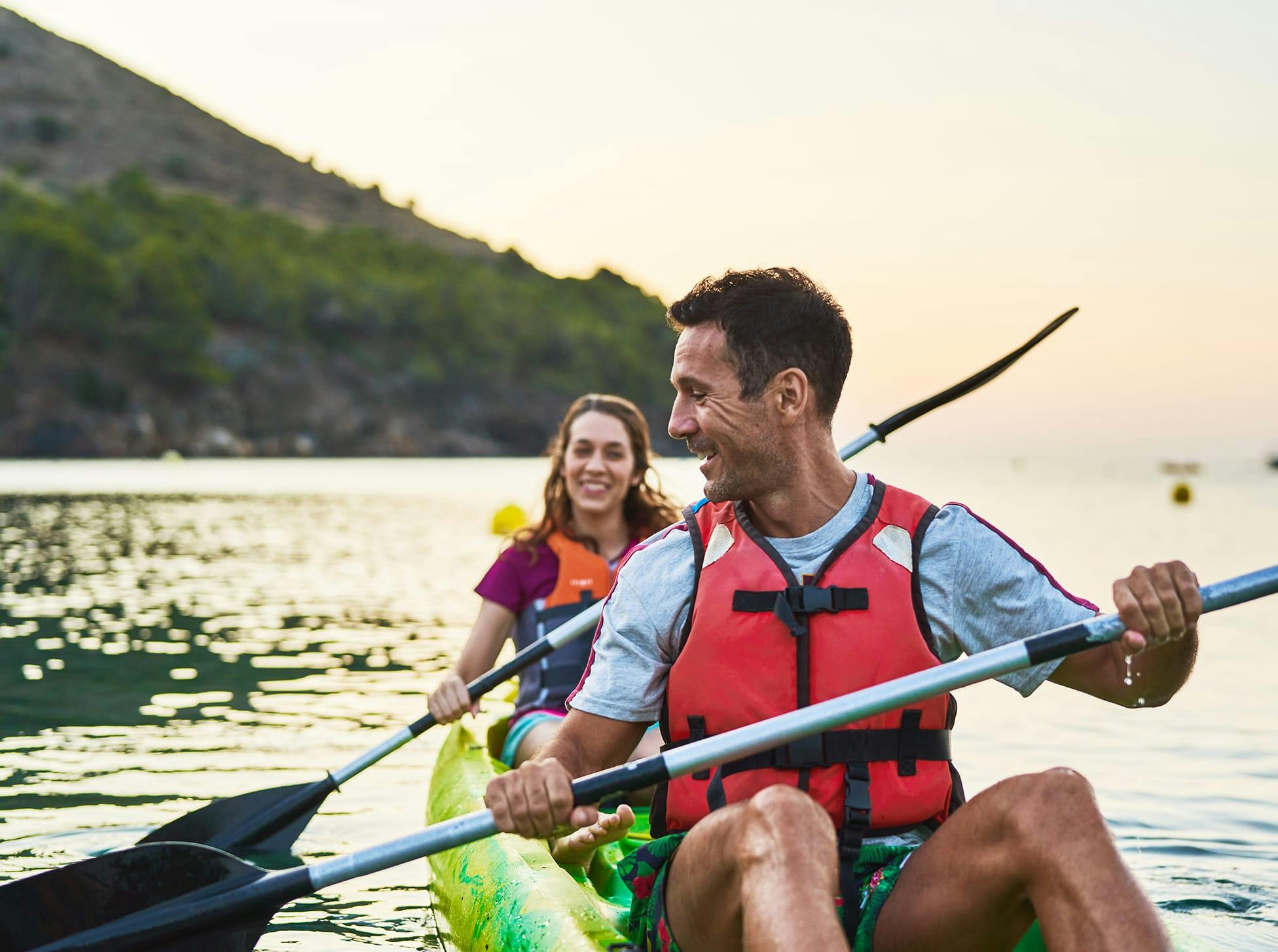 man and woman on a kayak