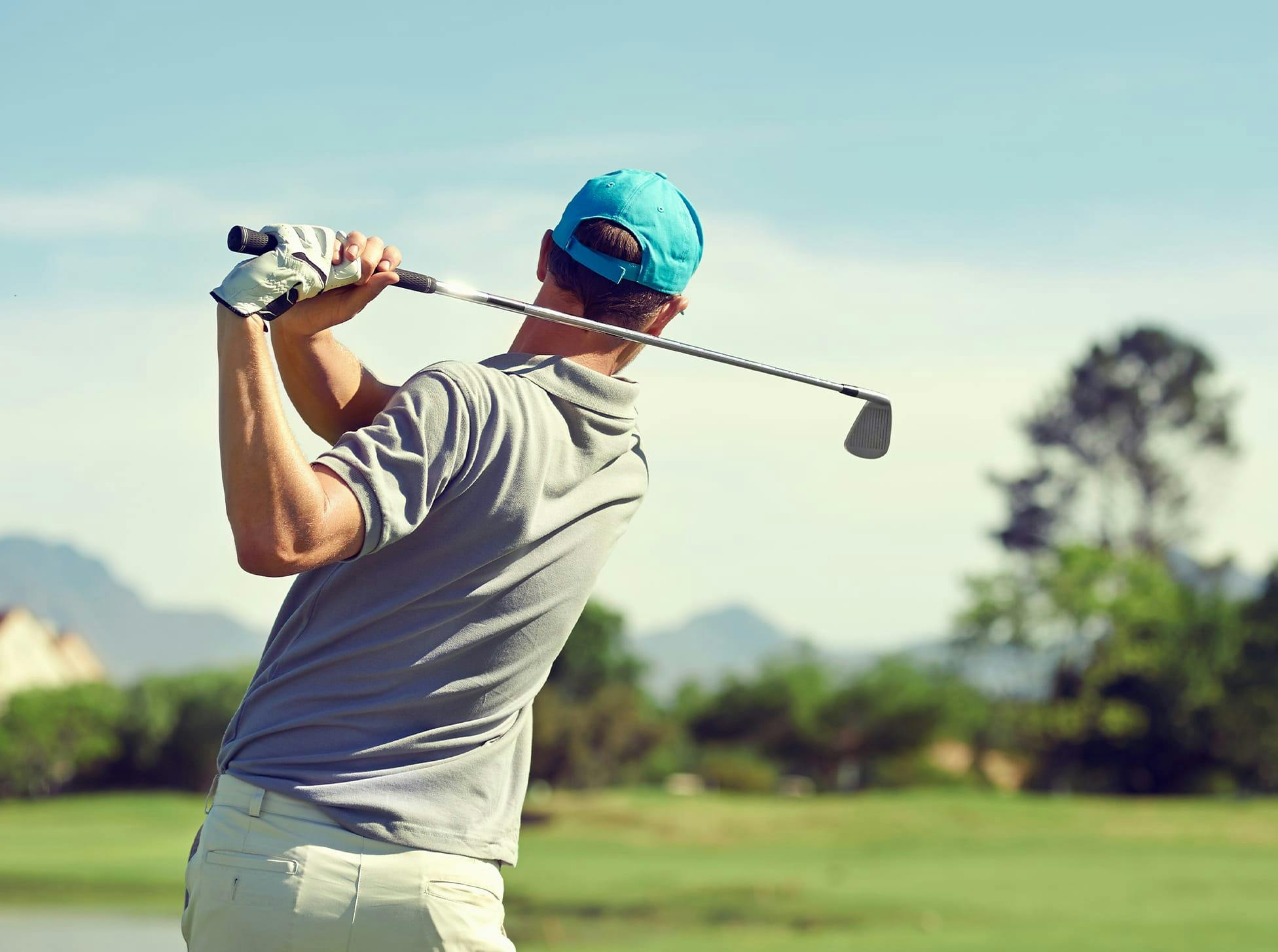 man swinging golf club