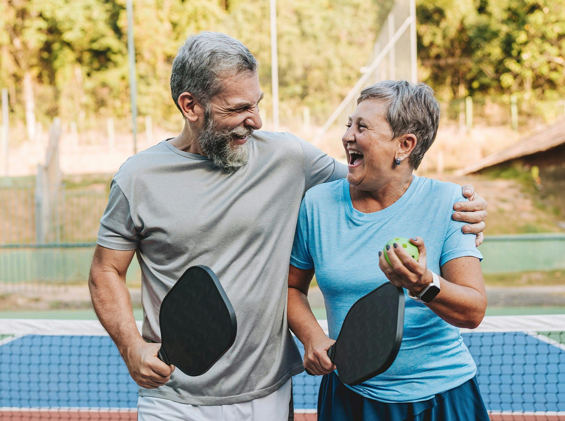 man and woman walking with golf clubs