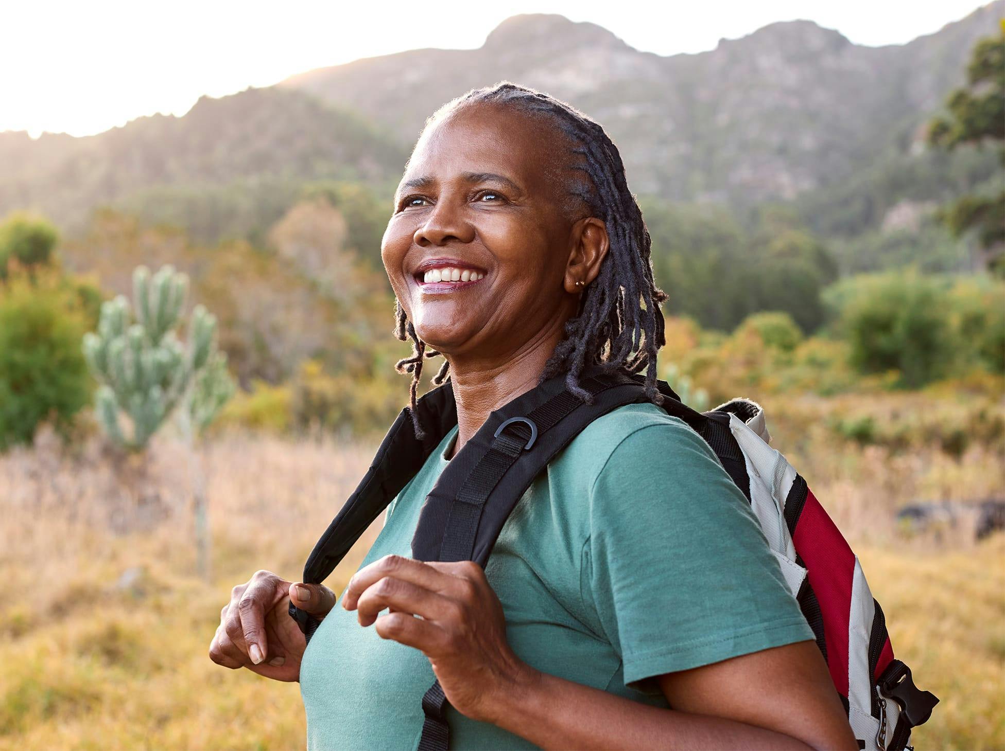 man wearing headphones on a dock, smiling