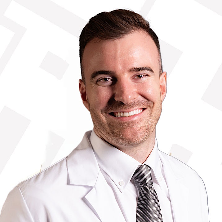 man in white  lab coat batton