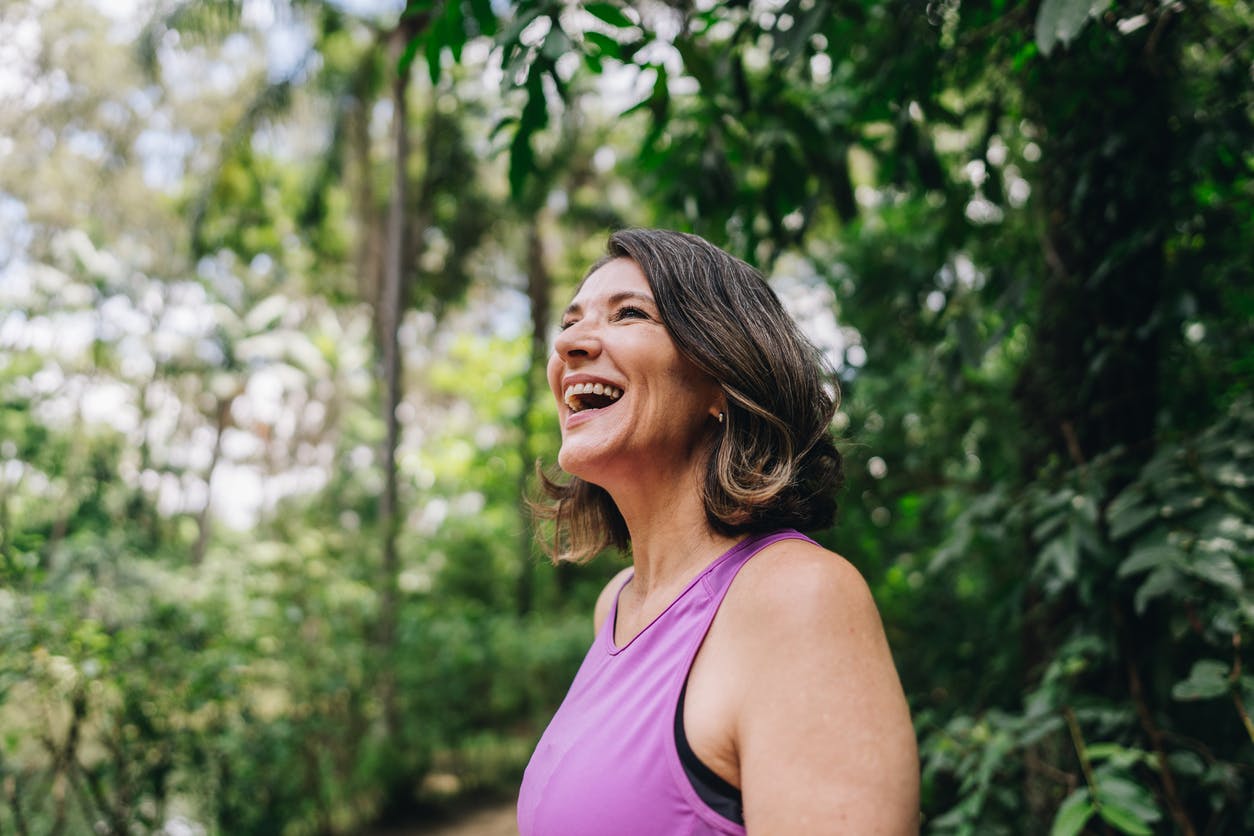 smiling woman in the forest