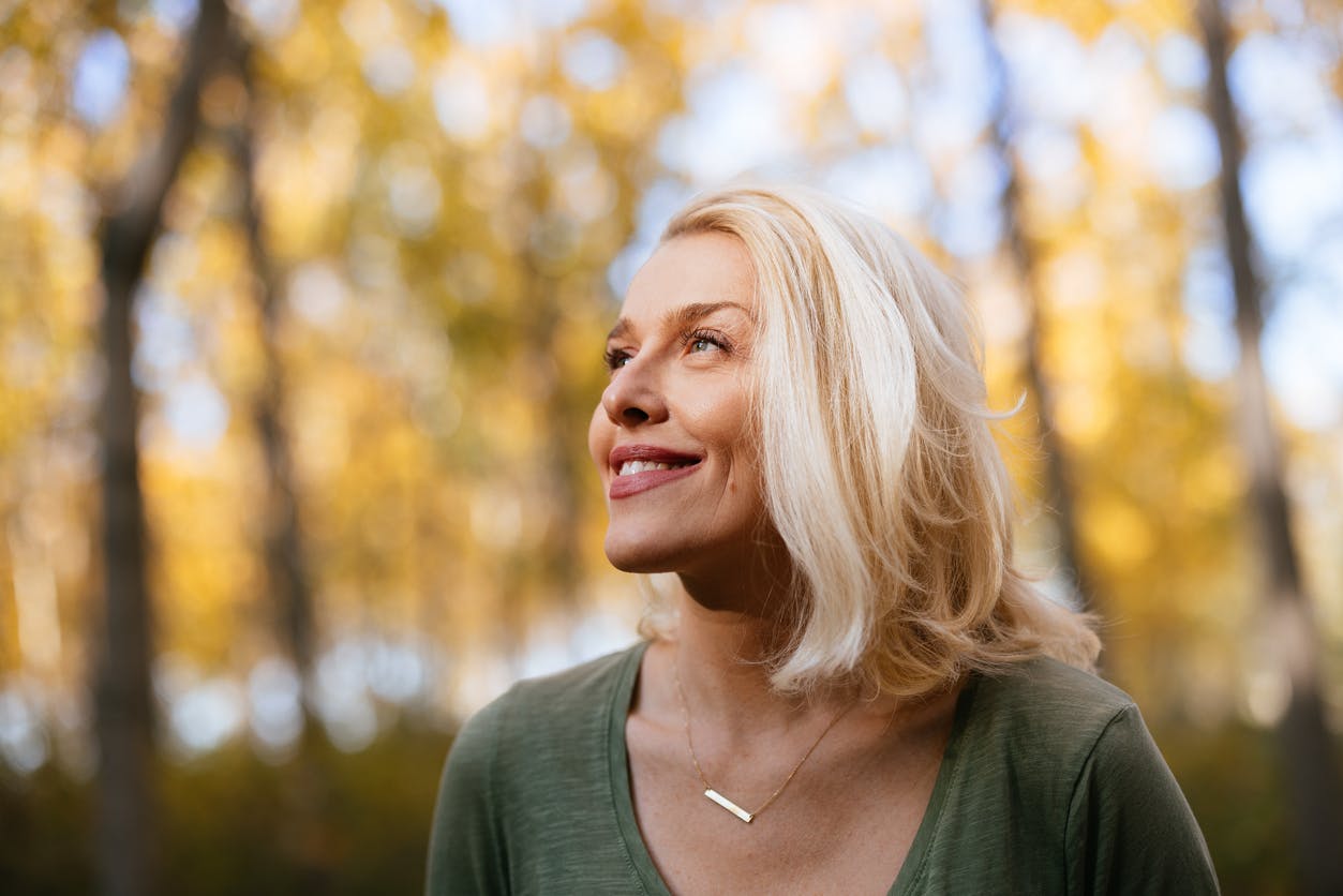 woman smiling in the woods