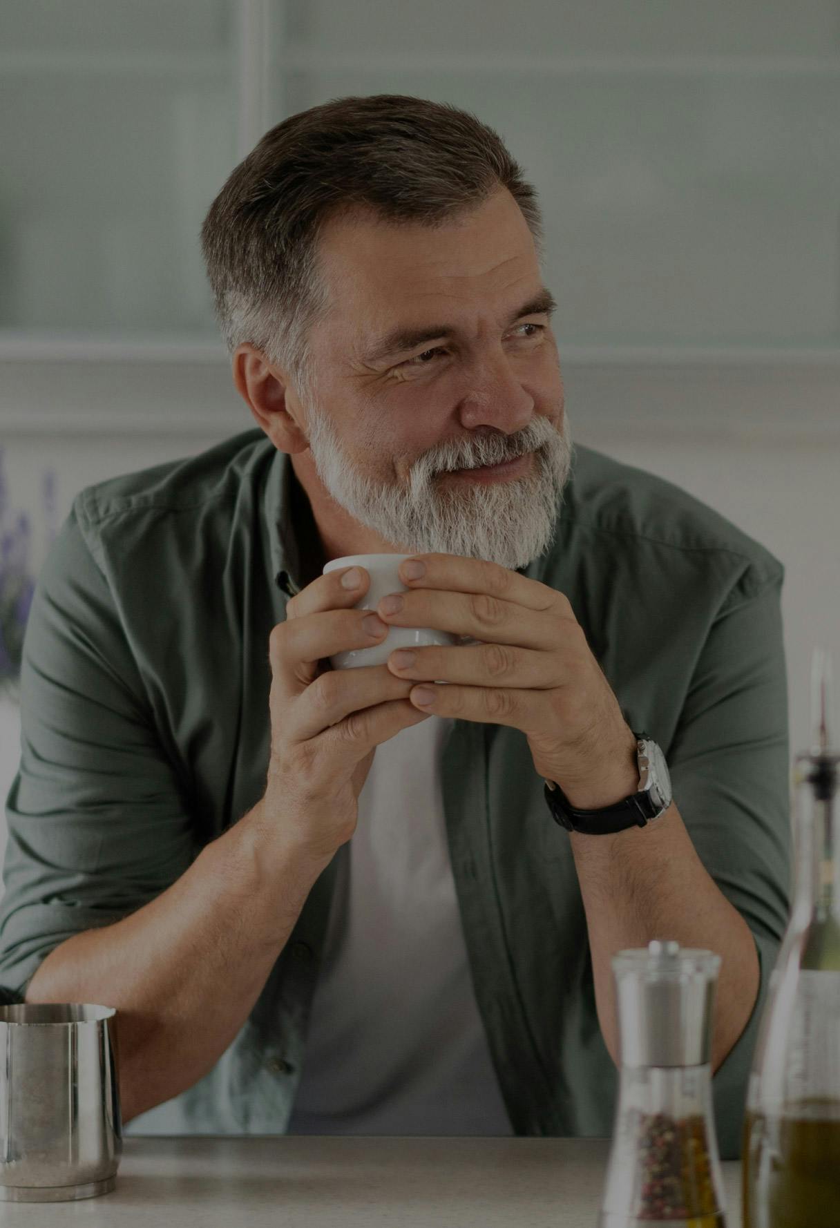 older man holding a cup of coffee