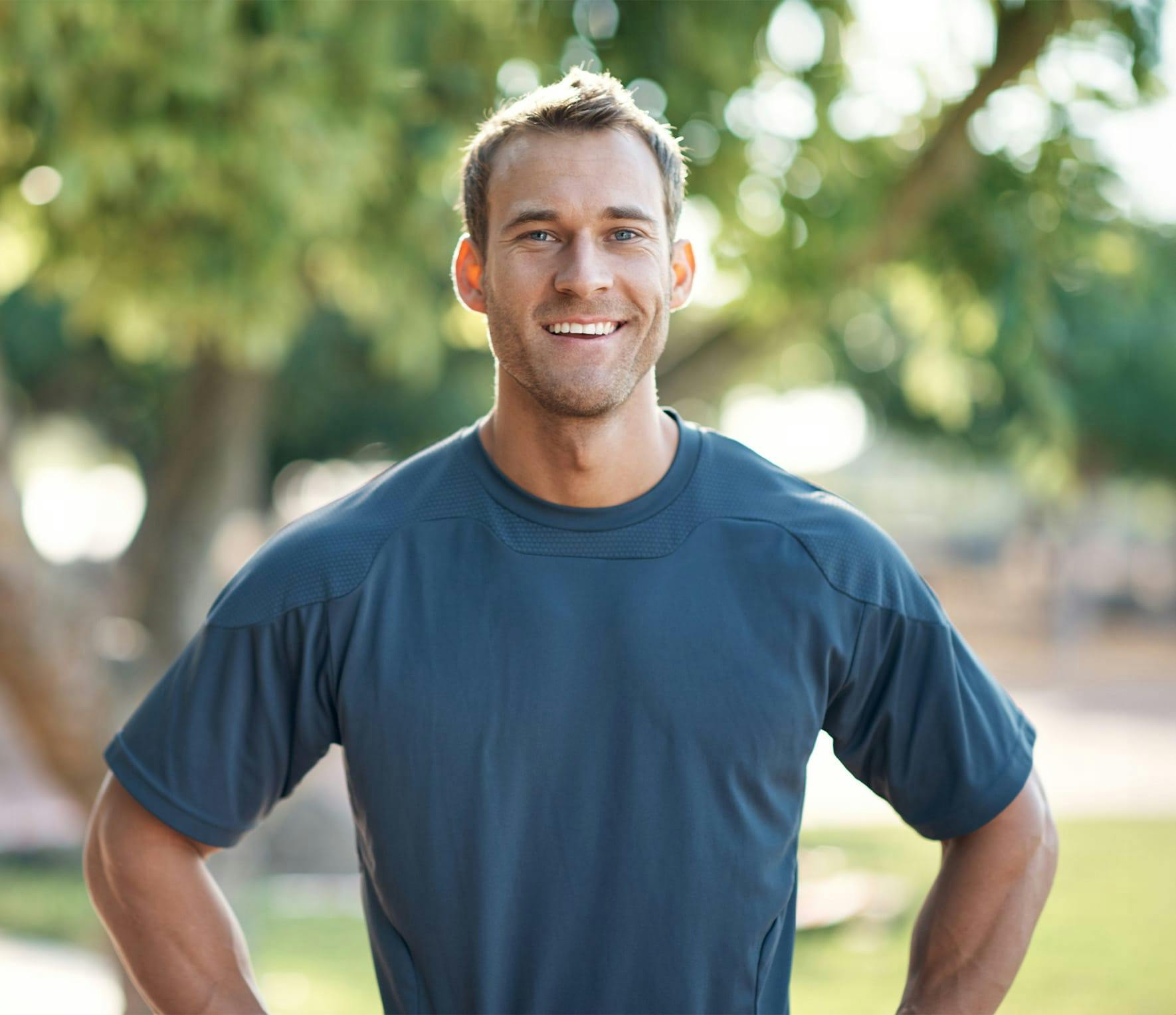 Athletic man smiling outside