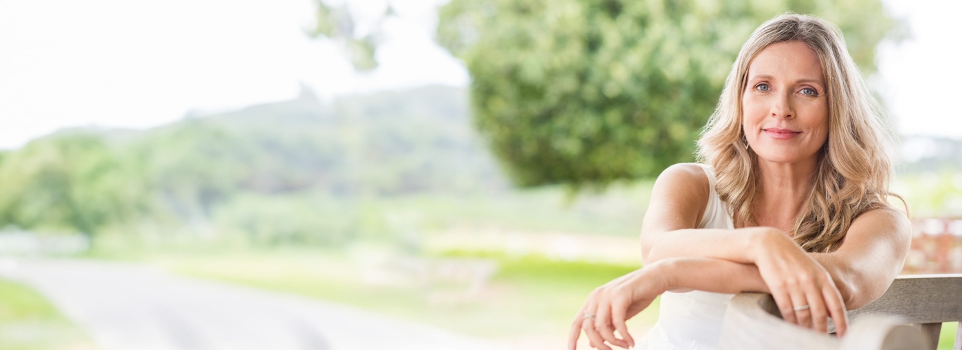 Blonde woman sitting outside