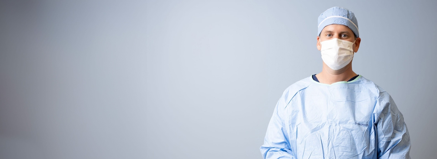 Dr. Gorscak in surgical scrubs and mask