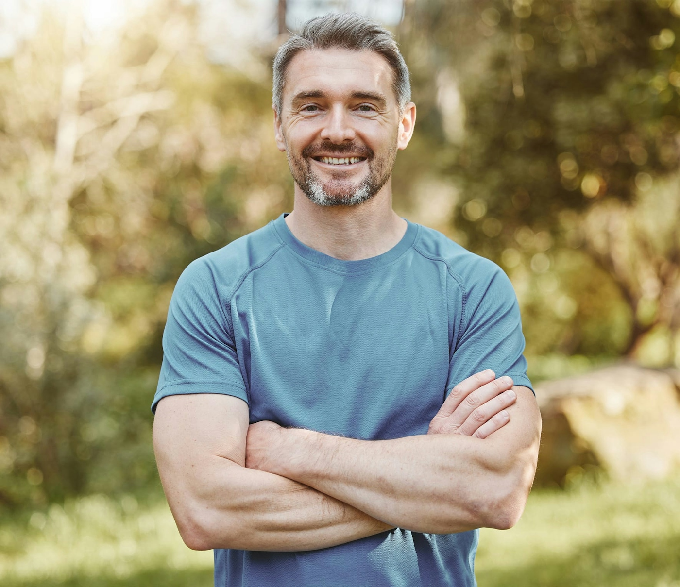 Man smiling with arms crossed