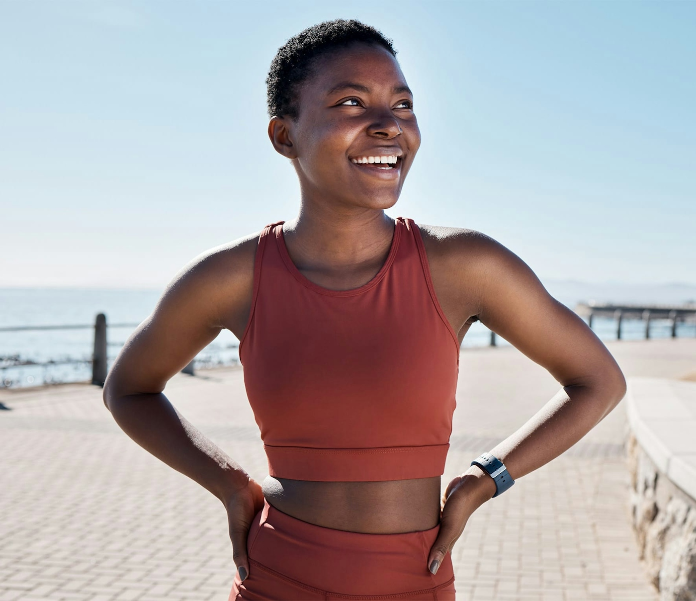 African american woman smiling at the beach