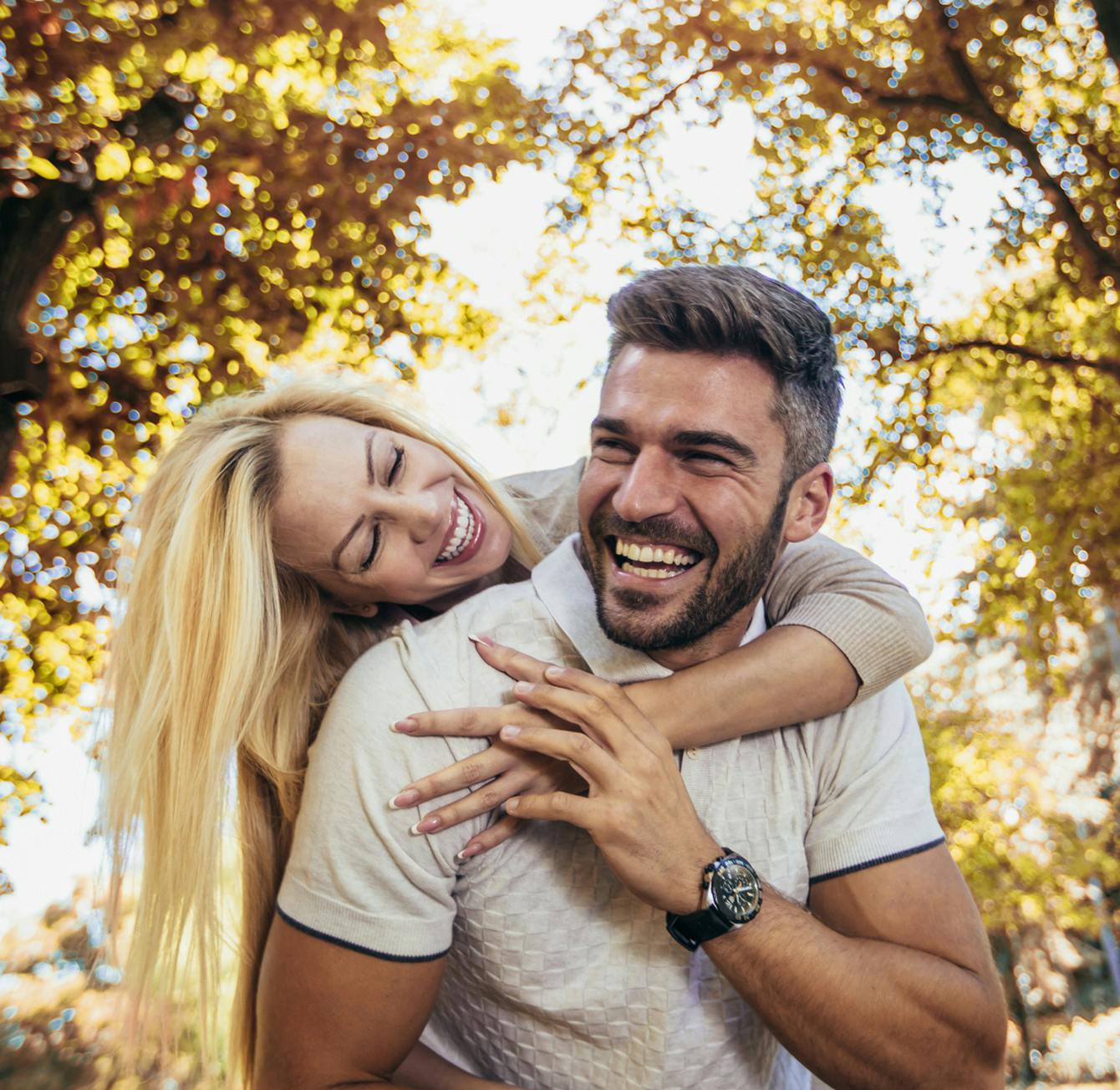 Woman giving a man a hug from behind