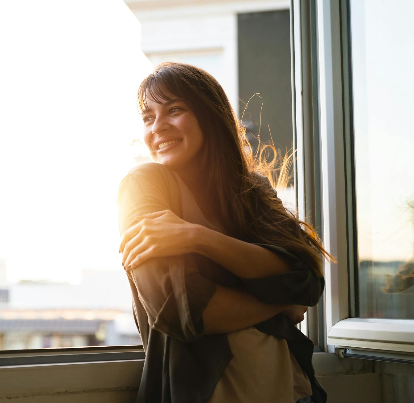Woman leaning against a balcony