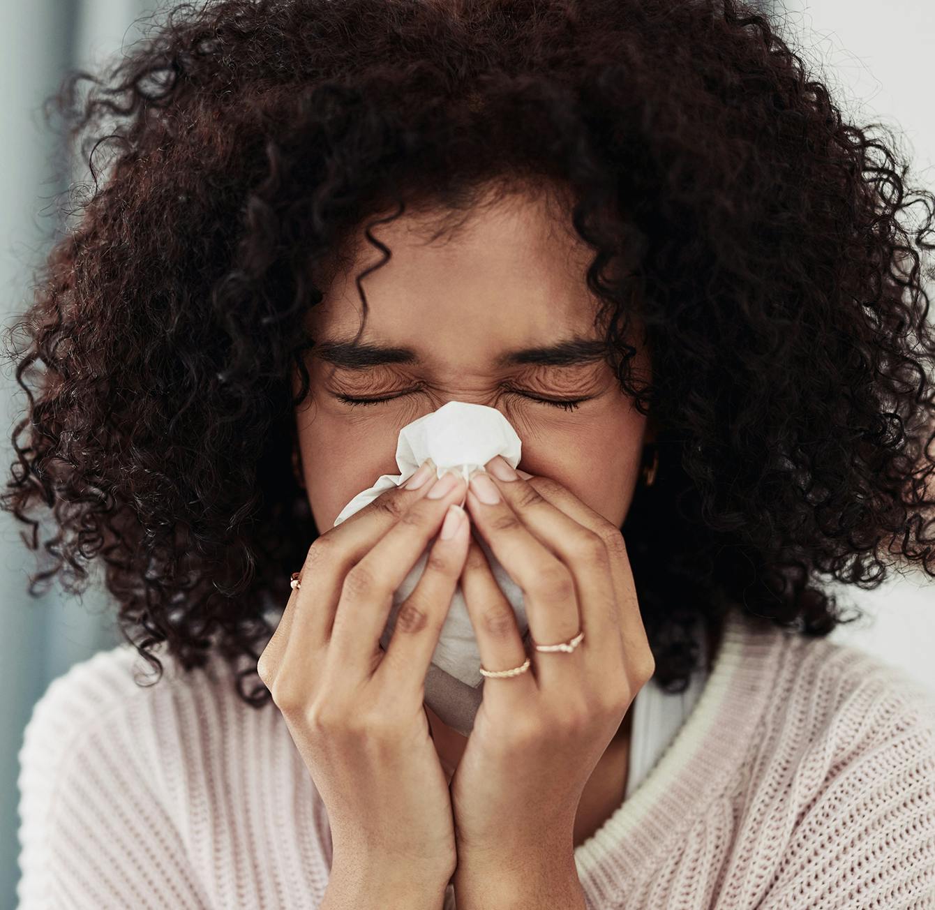 woman blowing nose