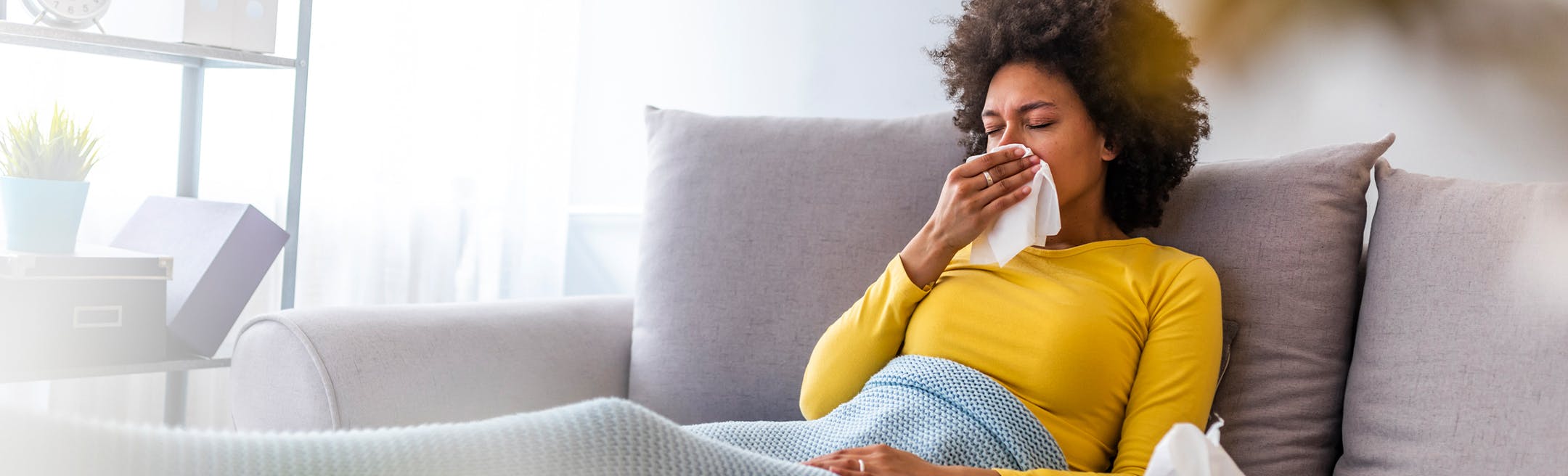 woman sick on couch