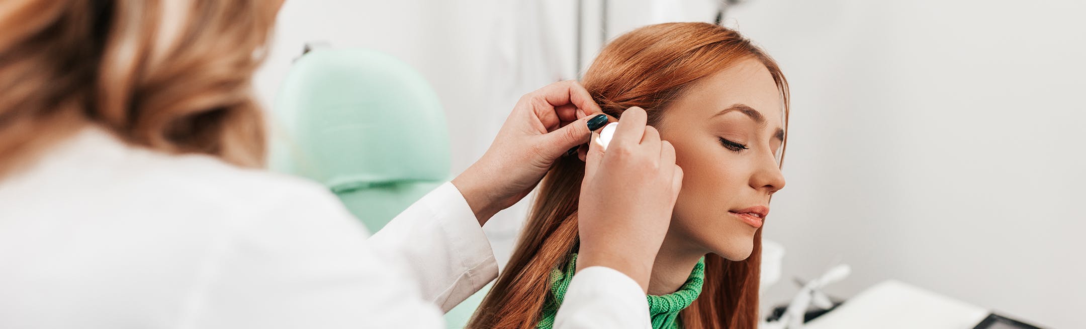 Woman receiving an ear treatment