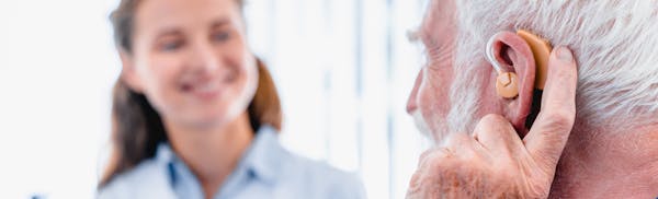 man checking his hearing aids