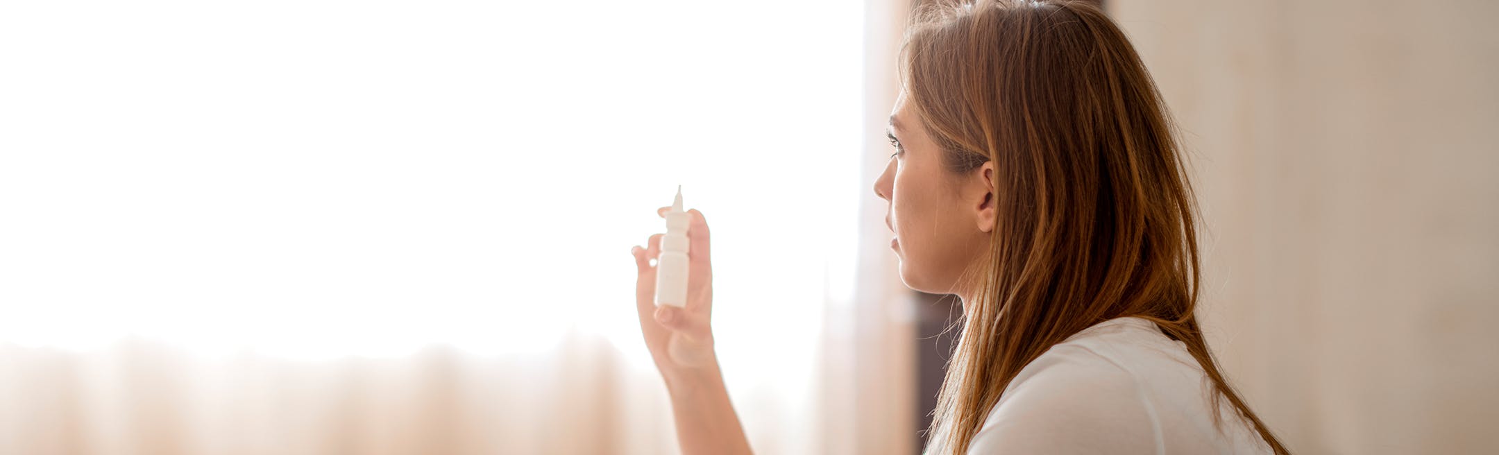 woman checking nasal spray