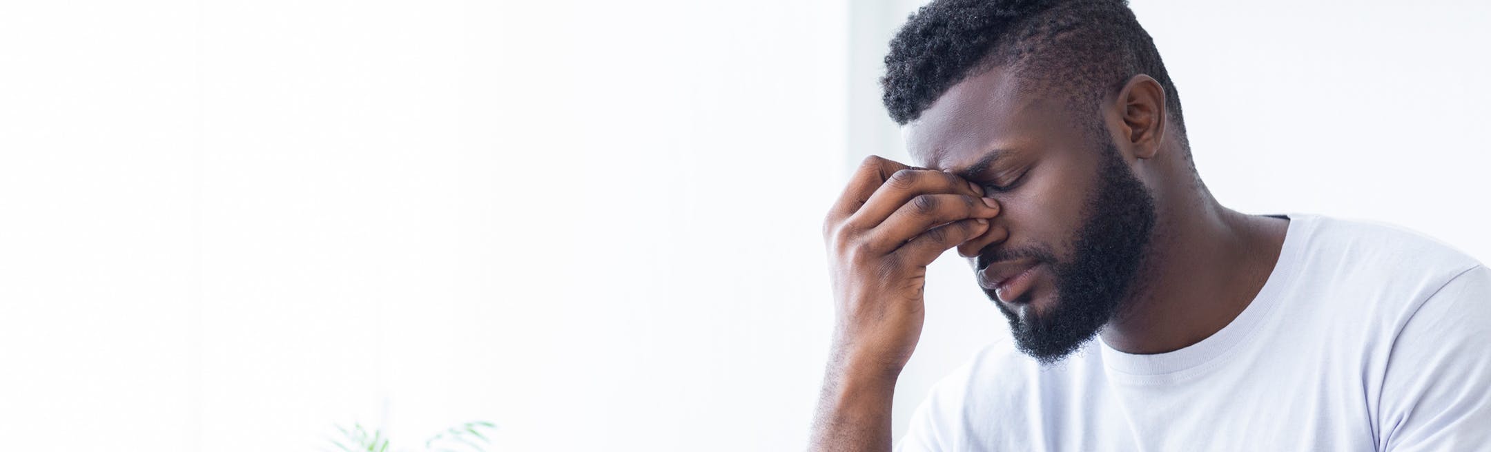 man holding nose