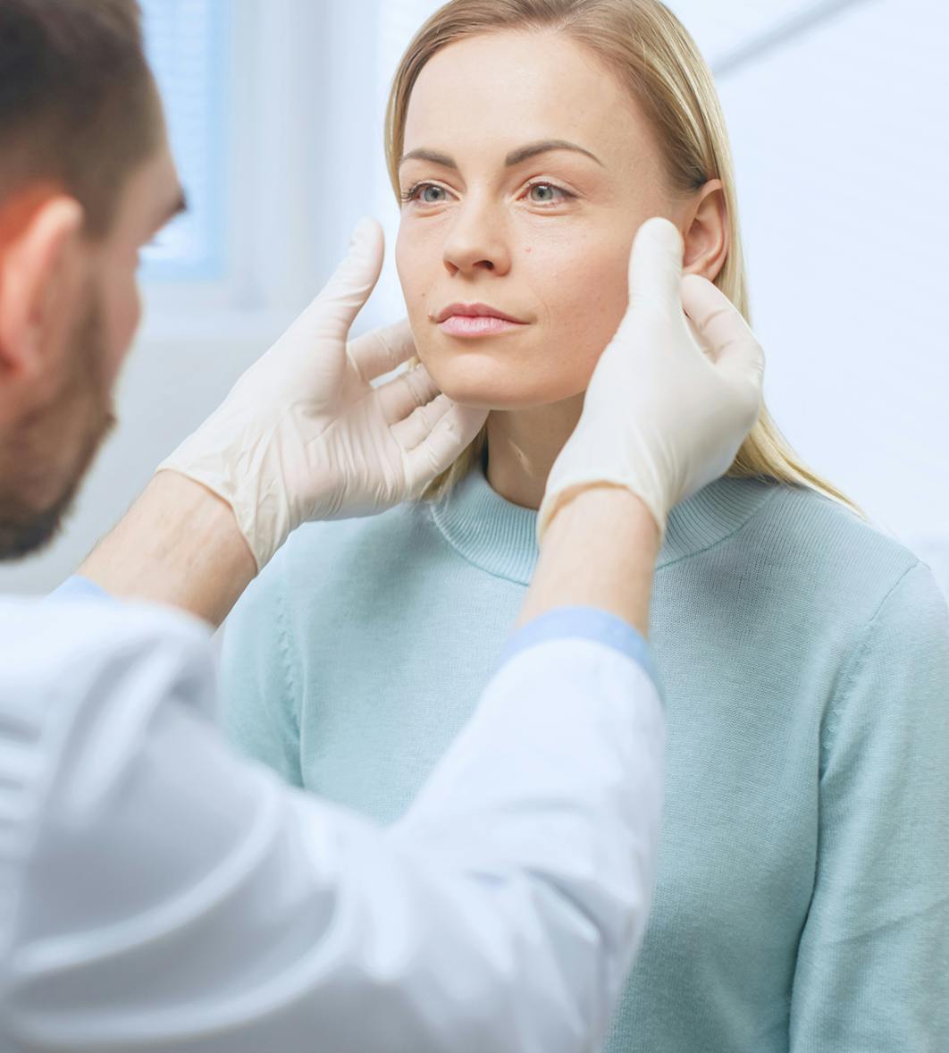 Doctor inspecting a patient's face