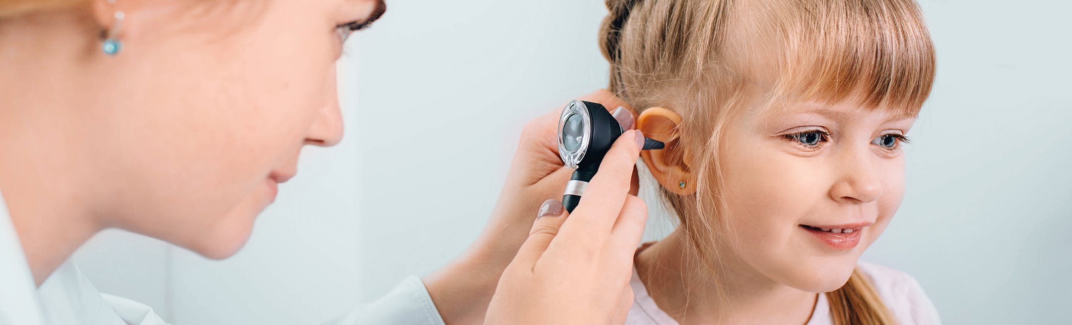 doctor checking child's ear