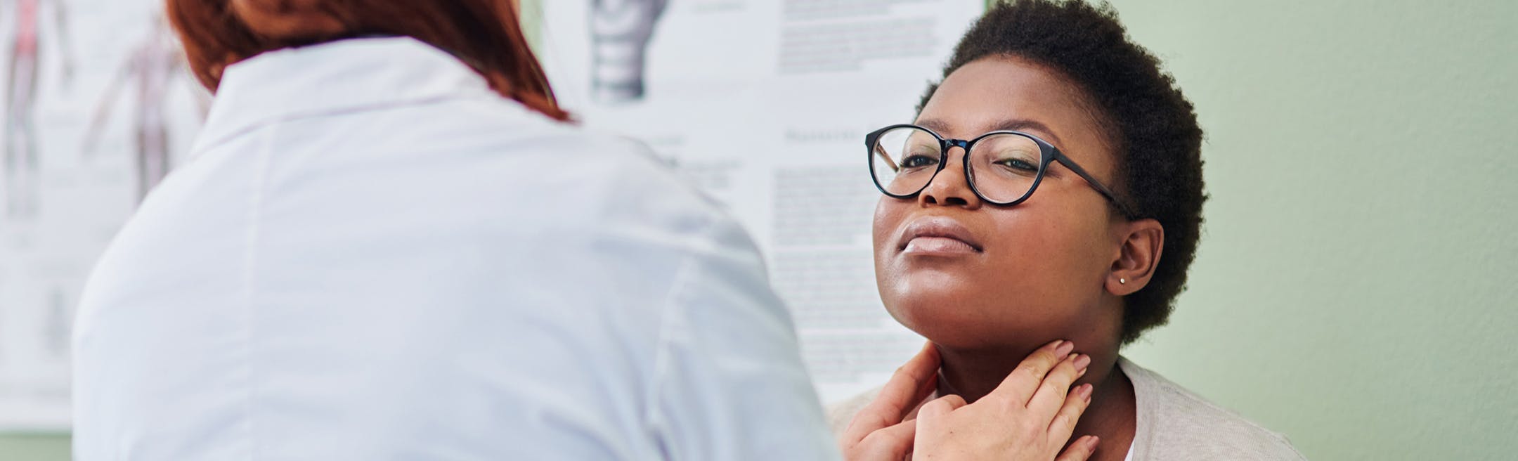 woman having her neck checked
