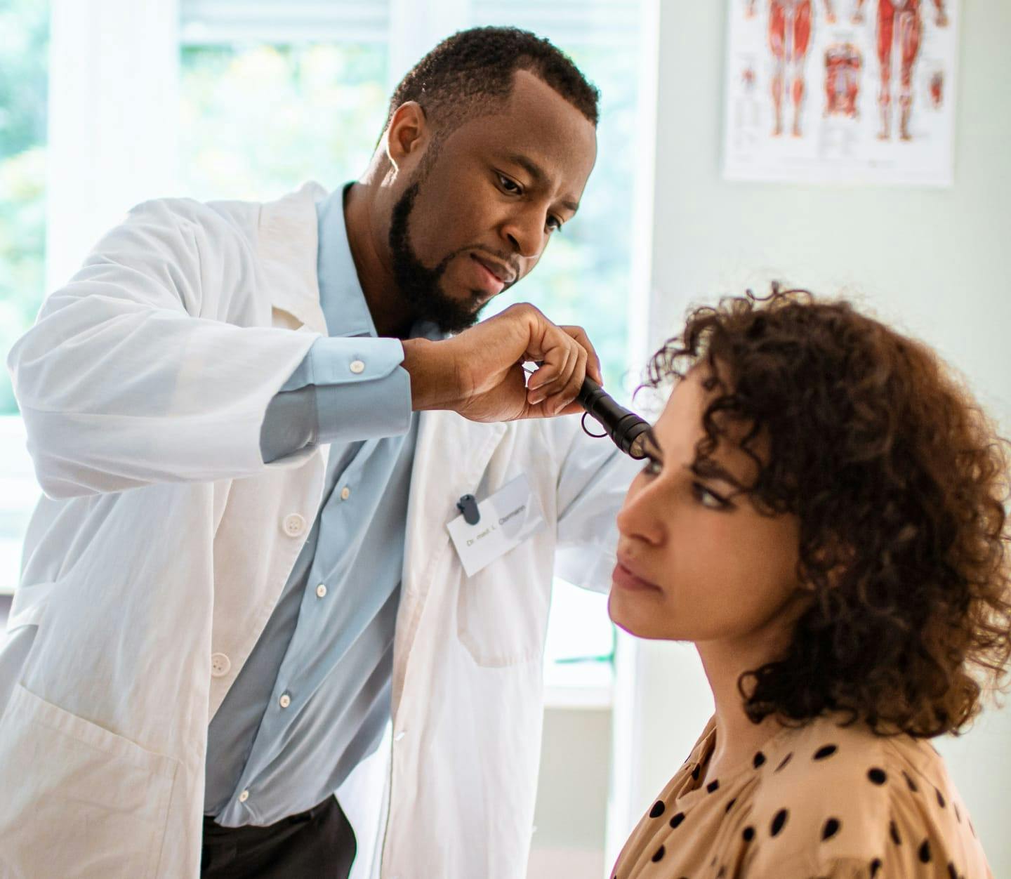 Physician examining a patient's ear