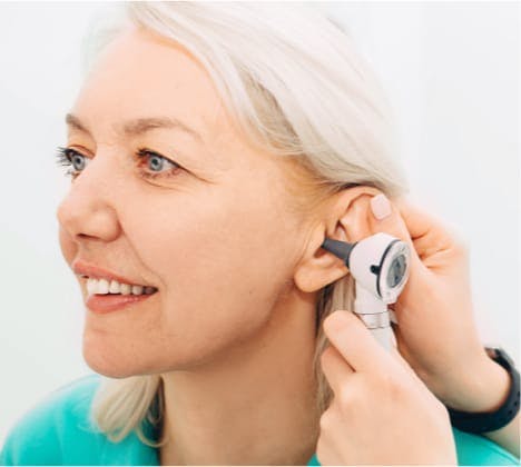 Woman having ear examined