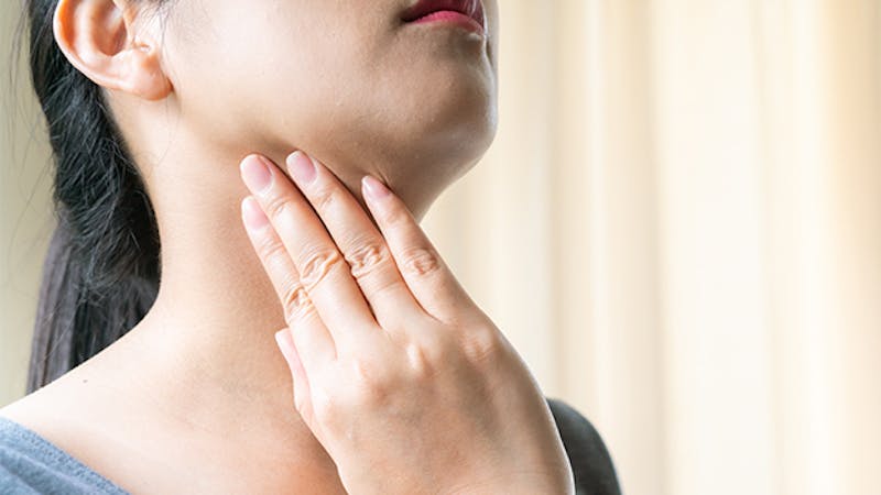 Woman touching her neck