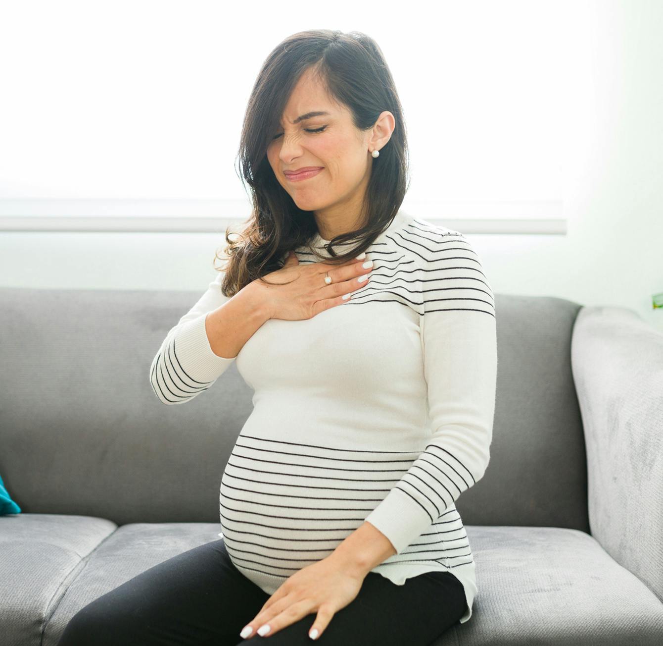 pregnant woman in discomfort from acid reflux