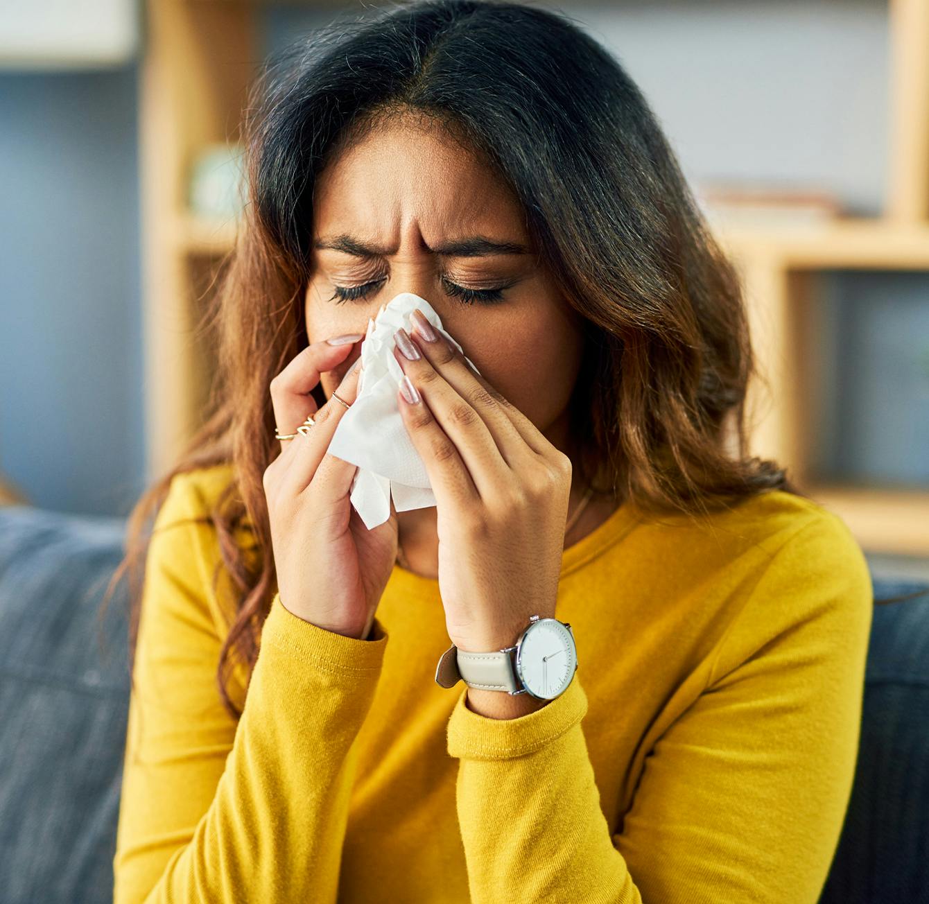 woman blowing her nose