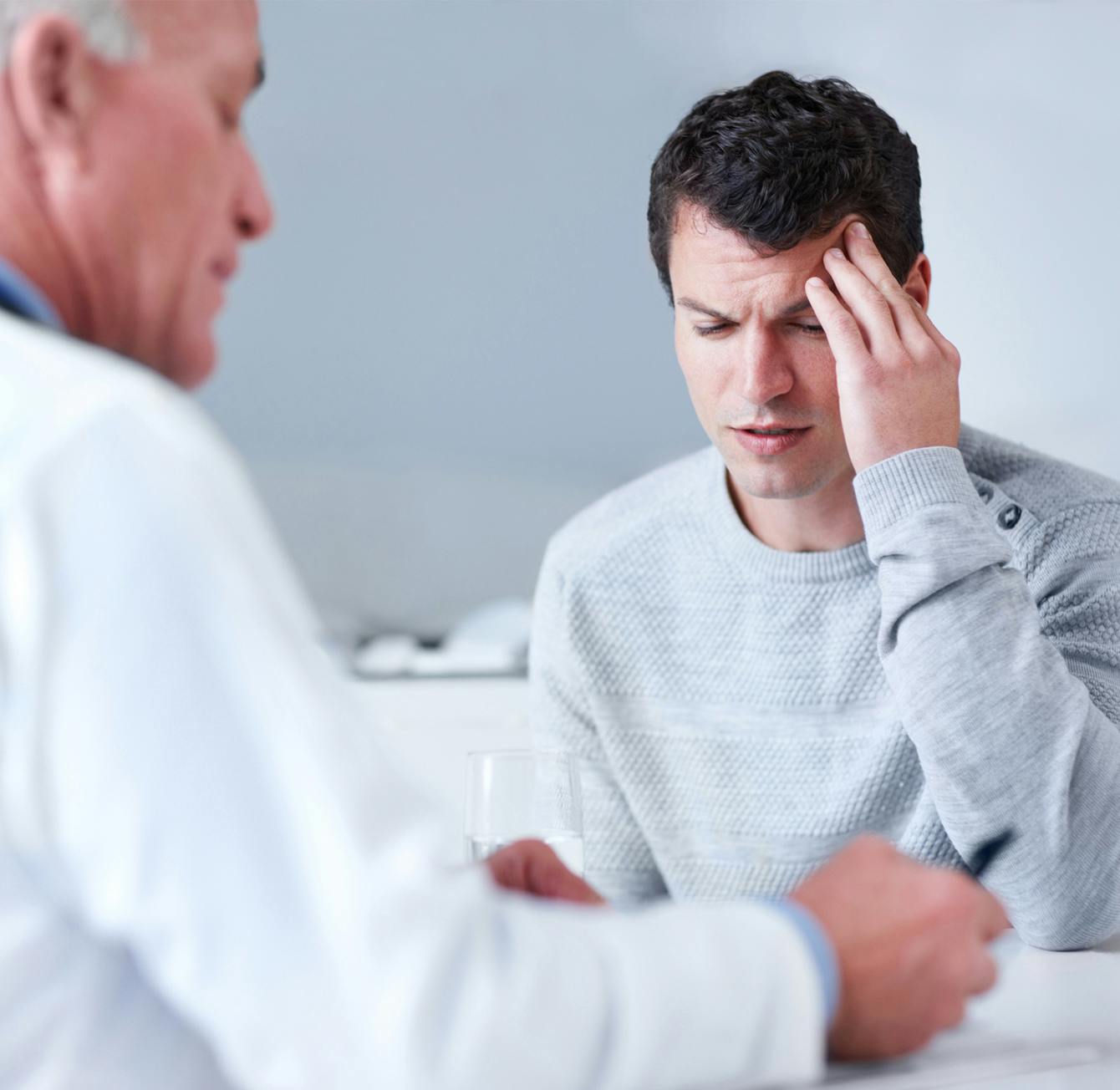 man touching his head in pain