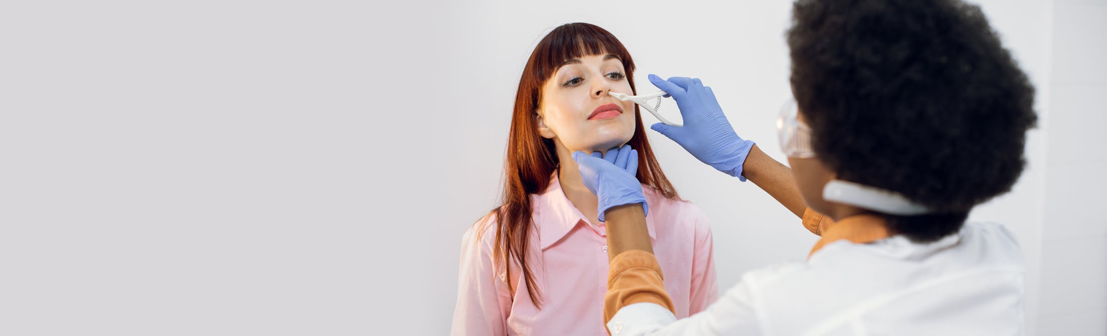 doctor performing nasal procedure