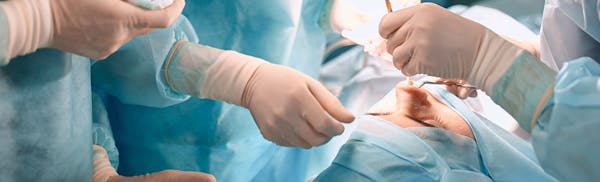 doctors working on a patient's nose
