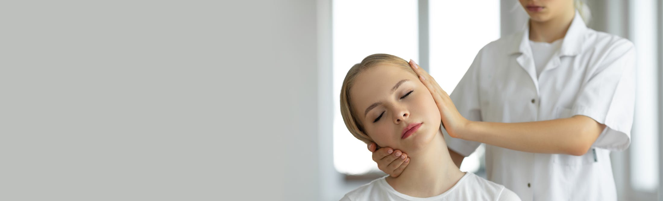 doctor working on a female patient's neck