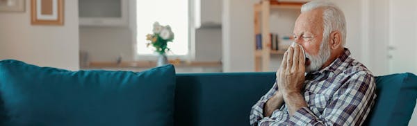 man blowing his name