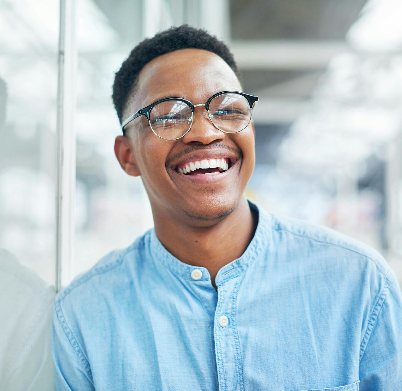 handsome young man wearing a blue shirt and glasses