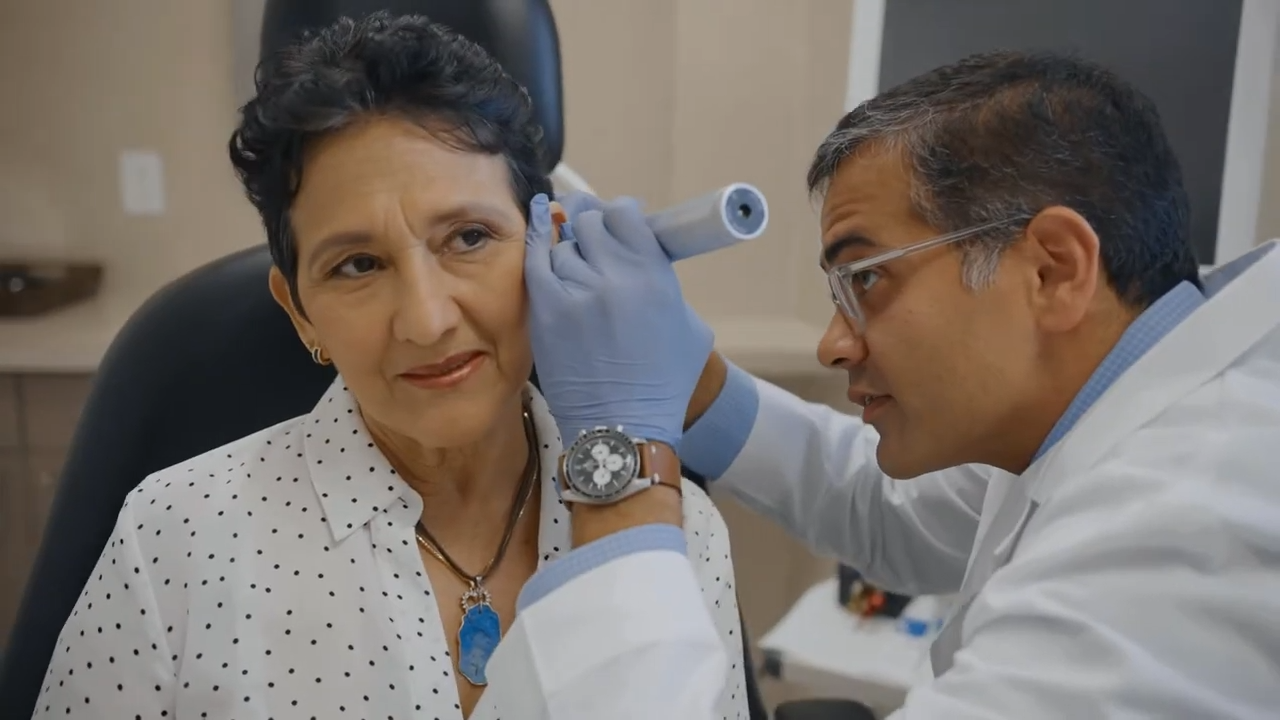 ENT doctor checking out woman's ear