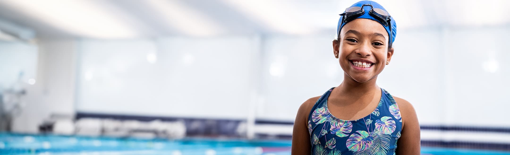 young girl in a bathing suit and swimcap