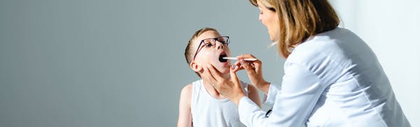 kid having his tonsils checked