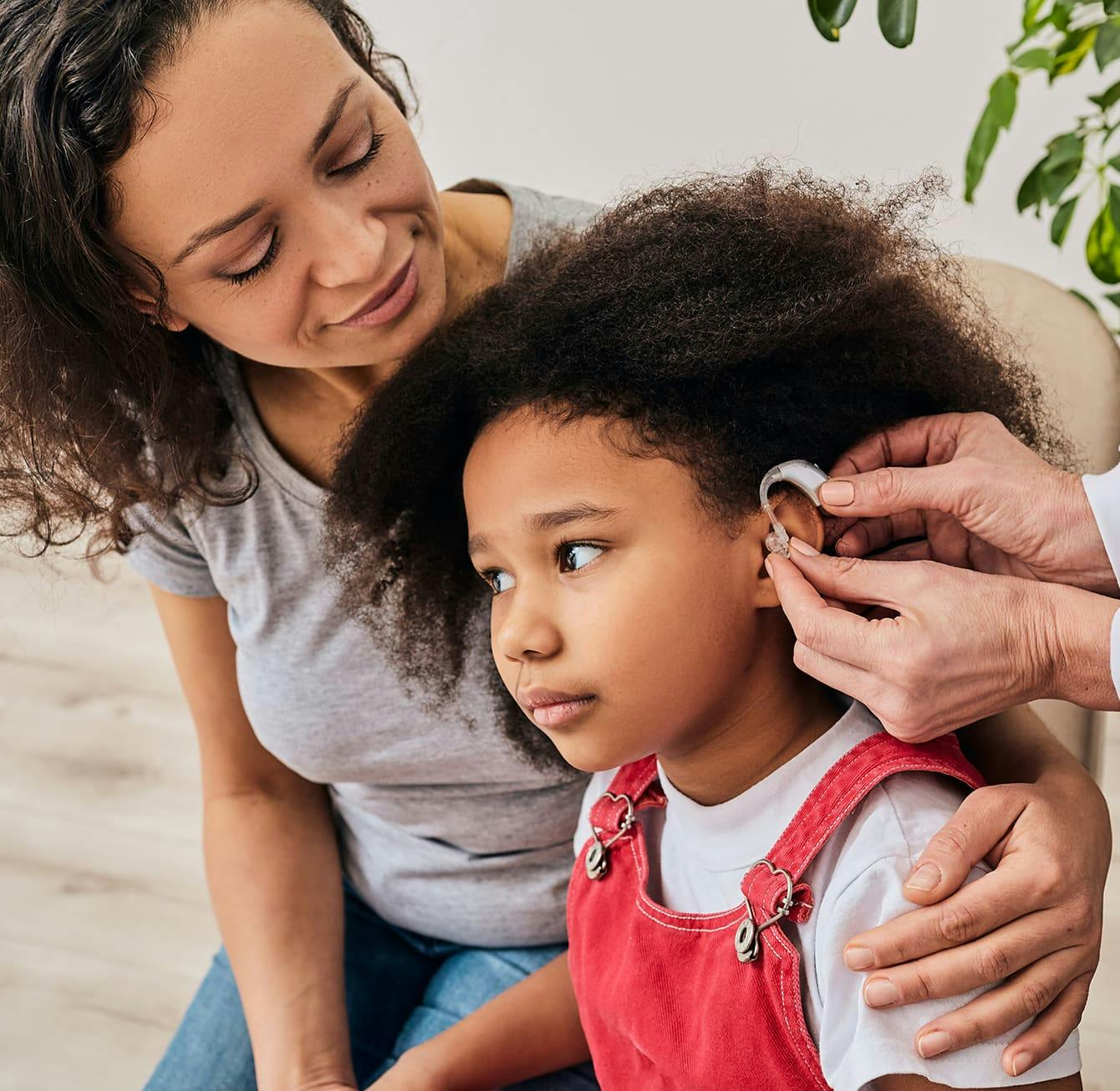 young girl getting a hearing aid