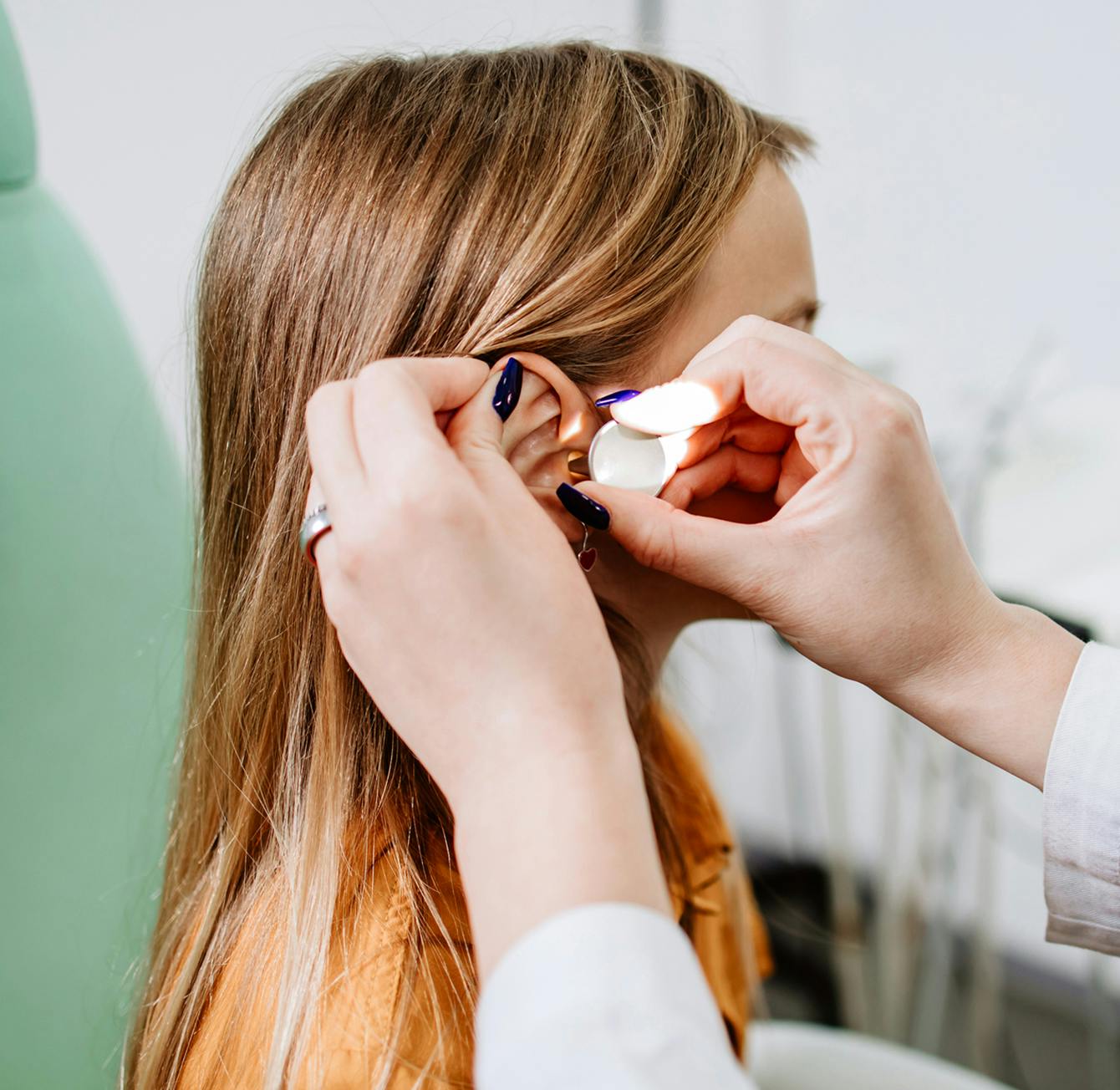 young girl getting hearing aids in