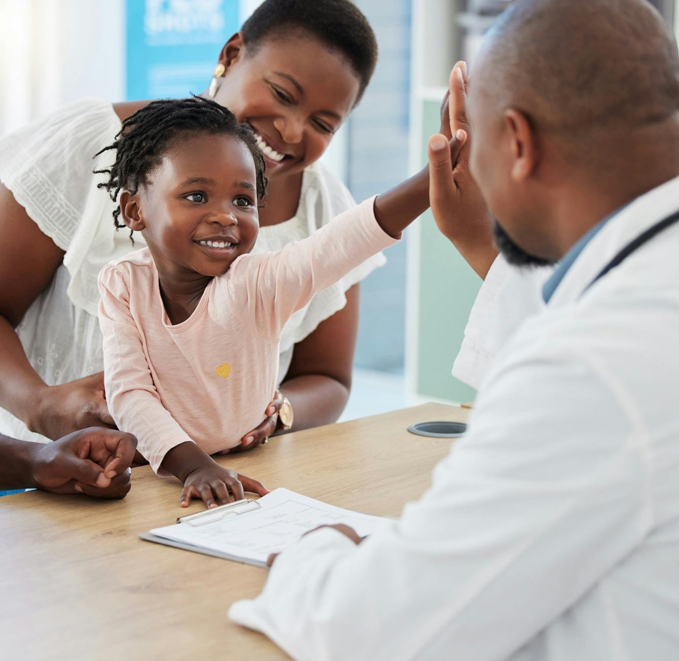doctor meeting a child and their mother